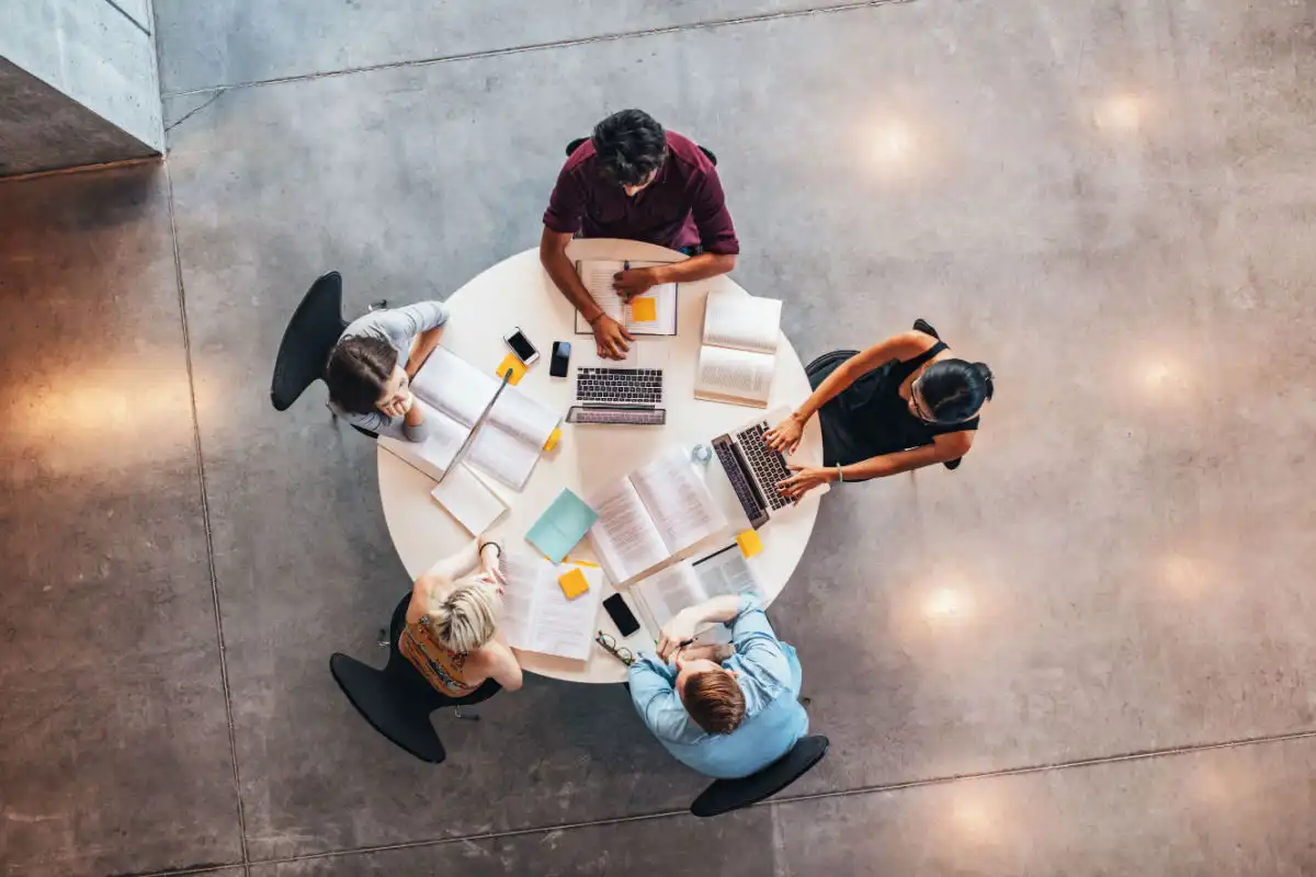 people sat around a table studying